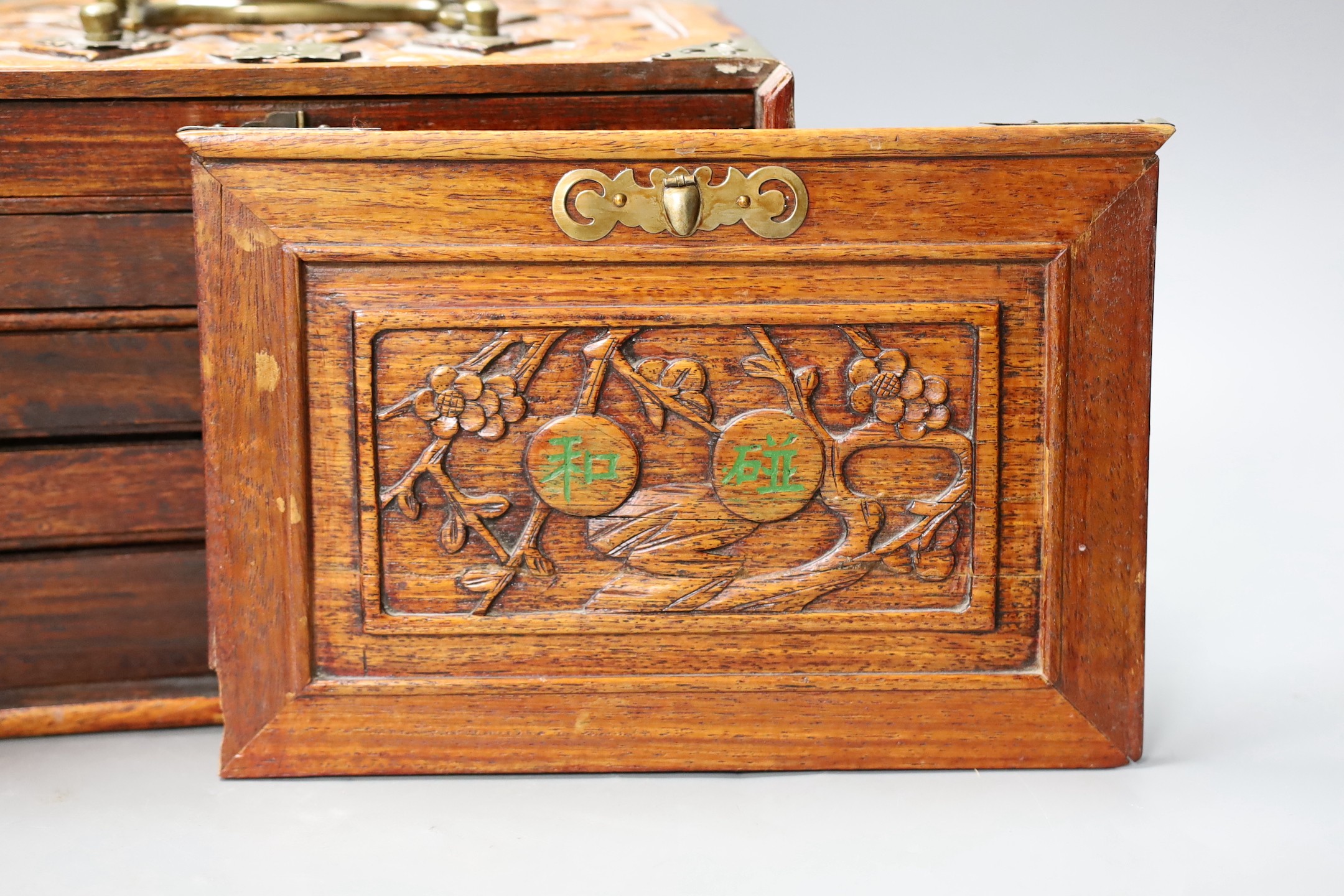 An early 20th century Chinese hardwood cased bone and bamboo mahjong set